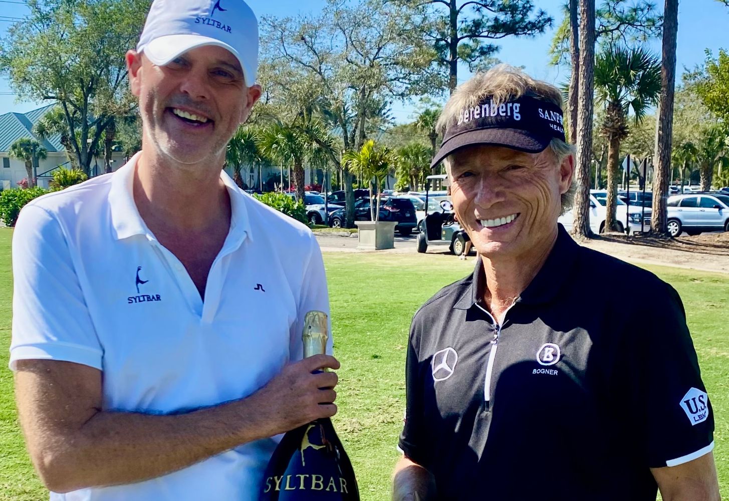 photo of SYLTBAR owner Claus at a charitable fundraiser holding a 3 liter bottle of Mr Big