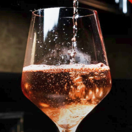 photo of a glass of mass produced big industry sparkling wine