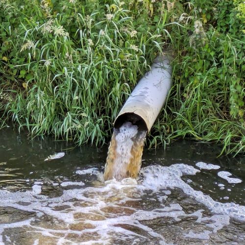 photo of polluted run-off pouring into a lake