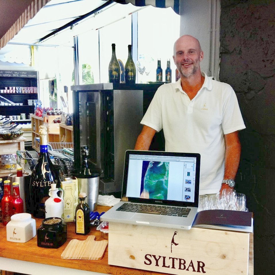 Photo of SYLTBAR owner Claus with SYLTBAR products at the Golden Hog market in Miami Florida